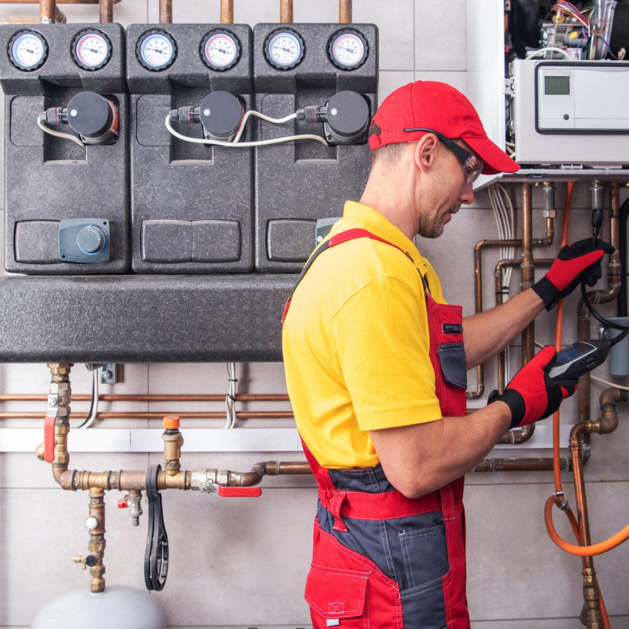 Professional Heating Engineer Making Regular Gas Heating System Performance and Safety Check. Residential Building Heat Installation Maintenance.